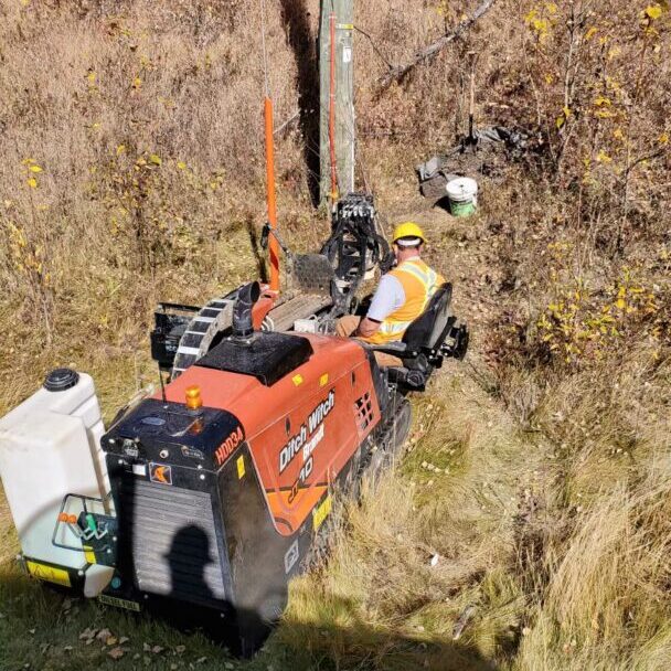 A crane is on the side of a hill.